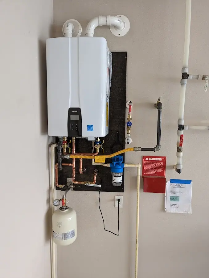 Professional plumber installing copper piping in a Round Rock home